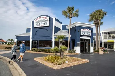 a man and woman walking in front of a building at The Nest Egg in Panama City Beach