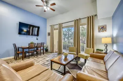 a living room with a couch and a table at Shores of Panama #124 by Book That Condo in Panama City Beach