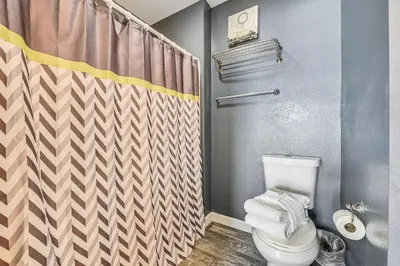 a bathroom with a toilet and a shower at Shores of Panama #124 by Book That Condo in Panama City Beach