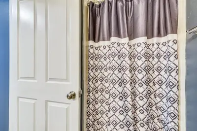a door with a curtain in a room at Shores of Panama #124 by Book That Condo in Panama City Beach