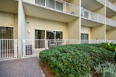 a building with balconies and bushes in front of it at Shores of Panama #124 by Book That Condo in Panama City Beach