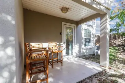 a patio with chairs and a table on a porch at Sunny Side Up by Book That Condo in Panama City Beach