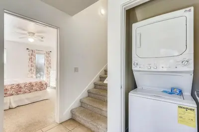 a living room with a staircase and a television at Sunny Side Up by Book That Condo in Panama City Beach