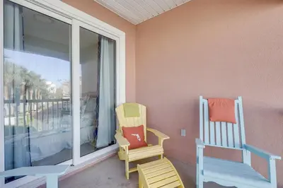 two chairs sitting on a porch next to a window at Sunny Side Up by Book That Condo in Panama City Beach
