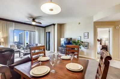 a living room with a dining room table with glasses on it at Origin at Seahaven #831 by Book That Condo in Panama City Beach