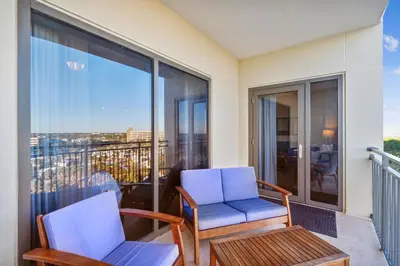 two chairs and a table on a balcony at Origin at Seahaven #831 by Book That Condo in Panama City Beach