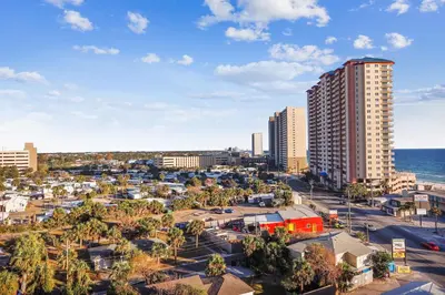 an aerial view of a city with buildings and the ocean at Origin at Seahaven #831 by Book That Condo in Panama City Beach
