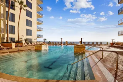a swimming pool in a hotel with a view of the ocean at Origin at Seahaven #831 by Book That Condo in Panama City Beach
