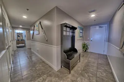 a hallway with a living room with a fireplace at Sterling Breeze - Luxury Beach Front Condo in Panama City Beach