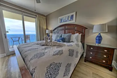 a bedroom with a bed with a view of the ocean at Sterling Breeze - Luxury Beach Front Condo in Panama City Beach