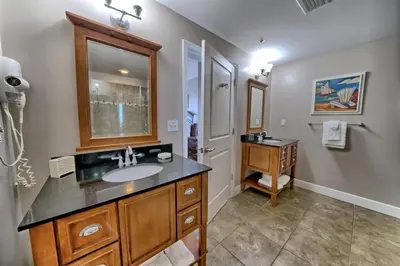a bathroom with a sink and a mirror at Sterling Breeze - Luxury Beach Front Condo in Panama City Beach