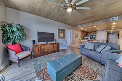 a living room with a couch and a flat screen tv at Sterling Breeze - Luxury Beach Front Condo in Panama City Beach