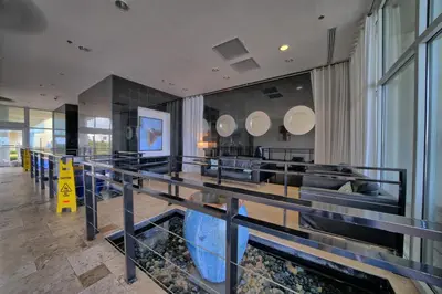 a restaurant with a fishtank in the middle of a room at Sterling Breeze - Cozy Beachfront One Bedroom Condo in Panama City Beach