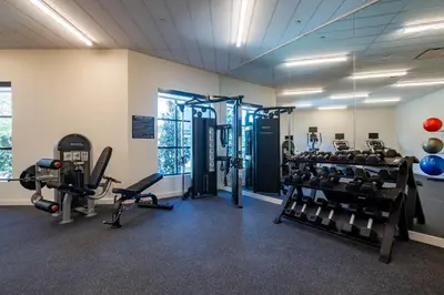 a gym with several treadmills and weights at The Lodge 30A in Santa Rosa Beach