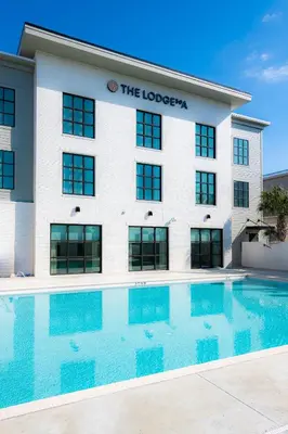 a hotel with a swimming pool in front of a building at The Lodge 30A in Santa Rosa Beach