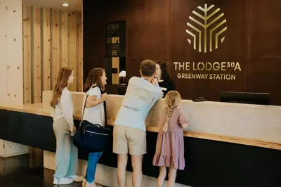 a group of people waiting at a reception desk at The Lodge 30A in Santa Rosa Beach