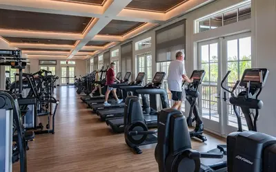 a group of people exercising on treadmills in a gym at Camp Creek Inn in Seacrest