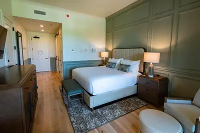a large bedroom with a bed and a couch at Camp Creek Inn in Seacrest
