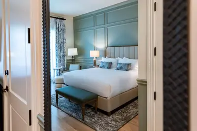 a bedroom with a bed and a blue wall at Camp Creek Inn in Seacrest