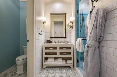 a bathroom with a sink and a toilet and a shower at Camp Creek Inn in Seacrest