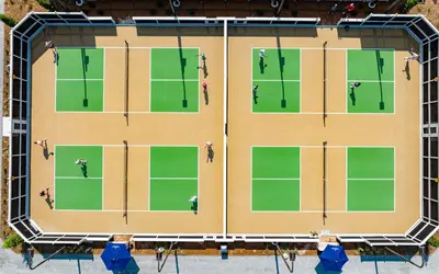 an overhead view of a tennis court with people on it at Camp Creek Inn in Seacrest