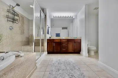 a bathroom with a tub and a sink and a toilet at Luxurious 4 Bedroom Condo! Gulf Views! Sleeps 10 & Easy Beach Access! by Dolce Vita Getaways PCB in Panama City Beach