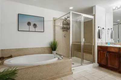 a bathroom with a large tub and a shower at Luxurious 4 Bedroom Condo! Gulf Views! Sleeps 10 & Easy Beach Access! by Dolce Vita Getaways PCB in Panama City Beach