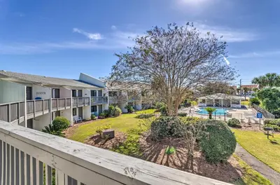 a balcony of a house with a yard at Santa Rosa Beach Studio Condo Less Than 1 Mi to Beach in Santa Rosa Beach