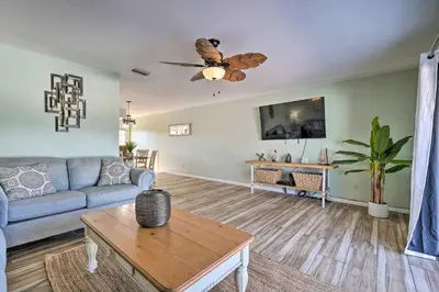 a living room with a couch and a table at The Sage PCB Family Getaway - Walk to Beach! in Panama City Beach