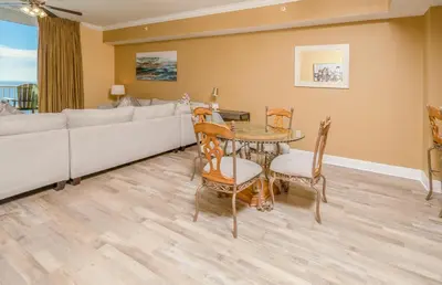 a living room with a couch and a table and chairs at Tidewater2808 in Panama City Beach