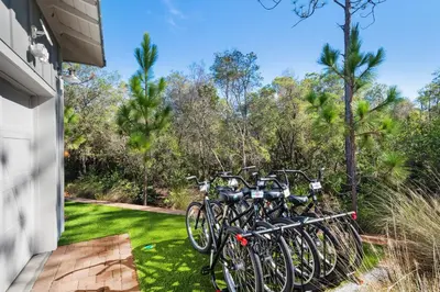 a row of bikes parked on the side of a house at Last Call at NatureWalk 30A in Seagrove Beach