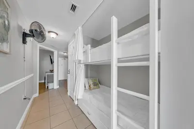 a bedroom with two bunk beds and a hallway at Seychelles 308 in Panama City Beach