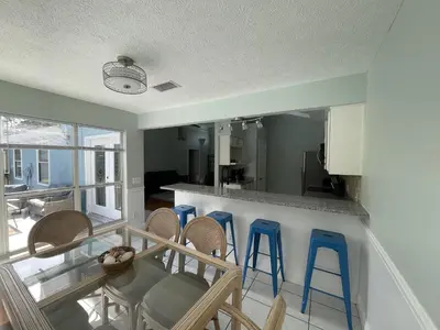 a kitchen and dining room with chairs and a table at A Shore Thing by Sand Seeker Vacations in Panama City Beach