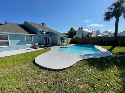 a swimming pool in the yard of a house at A Shore Thing by Sand Seeker Vacations in Panama City Beach