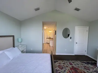 a bedroom with a bed and a bathroom at A Shore Thing by Sand Seeker Vacations in Panama City Beach