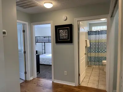 a hallway with a door leading to a bedroom at A Shore Thing by Sand Seeker Vacations in Panama City Beach