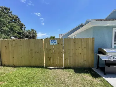 a fence with a speed limit sign in front of a house at A Shore Thing by Sand Seeker Vacations in Panama City Beach