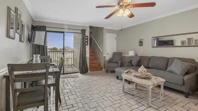 a living room with a couch and a table at Sweet Retreat by Sand Seeker Vacations in Panama City Beach