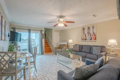 a living room with a couch and a table at Sweet Retreat by Sand Seeker Vacations in Panama City Beach