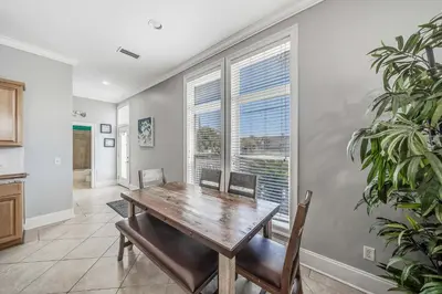 a dining room with a wooden table and chairs at Deja Blue by Sand Seeker Vacations in Panama City Beach