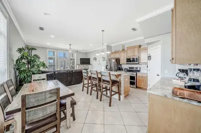 a large kitchen with a table and chairs and a counter at Deja Blue by Sand Seeker Vacations in Panama City Beach