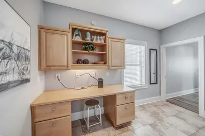 a home office with a wooden desk in a room at Deja Blue by Sand Seeker Vacations in Panama City Beach