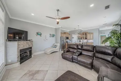 a living room with a couch and a fireplace at Deja Blue by Sand Seeker Vacations in Panama City Beach