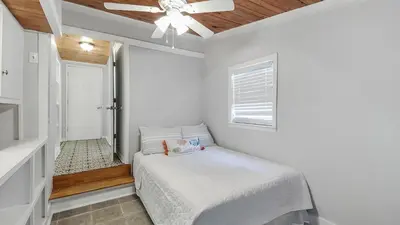a bedroom with a bed and a ceiling fan at Laguna Shores by Sand Seeker Vacations in Panama City Beach