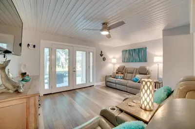 a living room with a couch and a table at PCB Townhome Walk to Beaches, Resort Amenities! in Panama City Beach