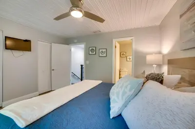 a bedroom with a bed and a ceiling fan at PCB Townhome Walk to Beaches, Resort Amenities! in Panama City Beach