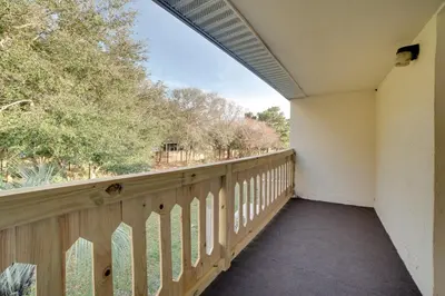 a balcony with a view of a yard at PCB Townhome Walk to Beaches, Resort Amenities! in Panama City Beach