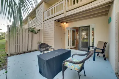 a patio with two chairs and a table on a house at PCB Townhome Walk to Beaches, Resort Amenities! in Panama City Beach