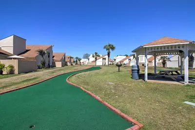 a green golf course with a gazebo at PCB Townhome Walk to Beaches, Resort Amenities! in Panama City Beach
