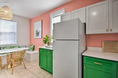 a kitchen with green cabinets and a white refrigerator at Easy Walk to Seagrove Beach Beverly Bungalow in Santa Rosa Beach